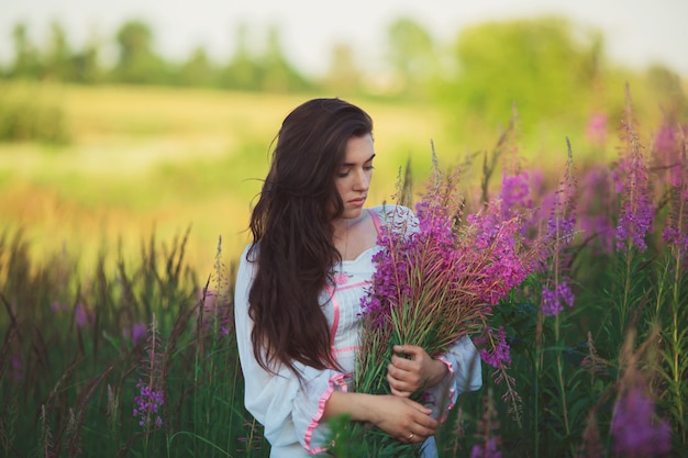 Beautiful woman standing in a field