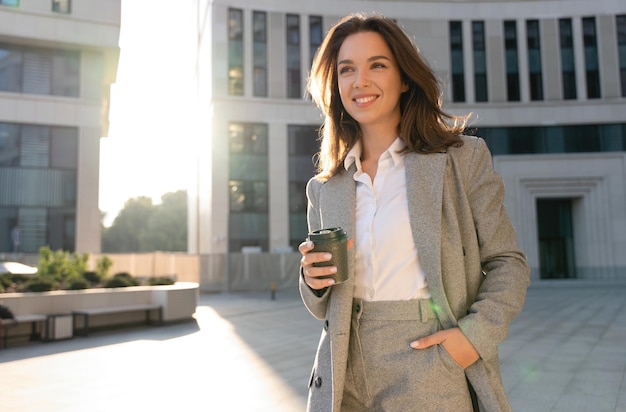 Beautiful Woman Standing With Coffee Near Office Building Portrait Of Successful Woman Holding Cup Of Hot Drink