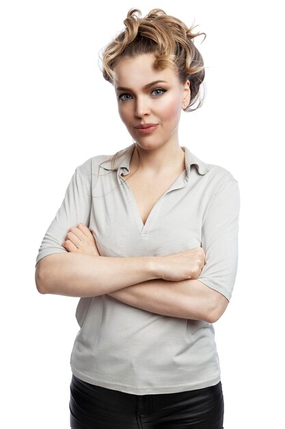 A beautiful woman stands with crossed arms Smiling blonde in a gray tank top Confidence and success Isolated on white background Vertical