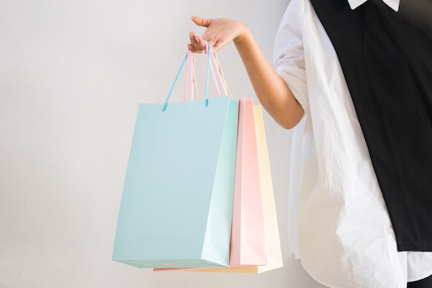 Beautiful woman stop walking after holding many shopping bags on parking.