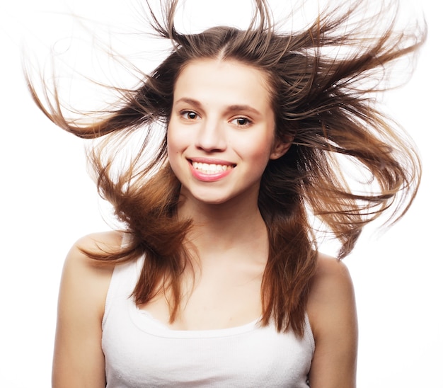 Beautiful woman in studio shot with wind on hair .