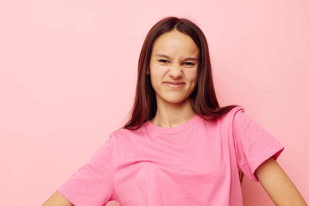 Beautiful woman in stylish clothes posing emotions pink background