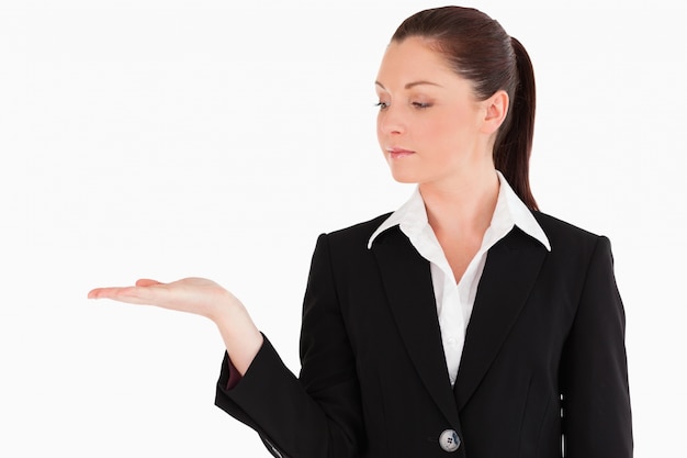 Beautiful woman in suit showing a copy space while standing