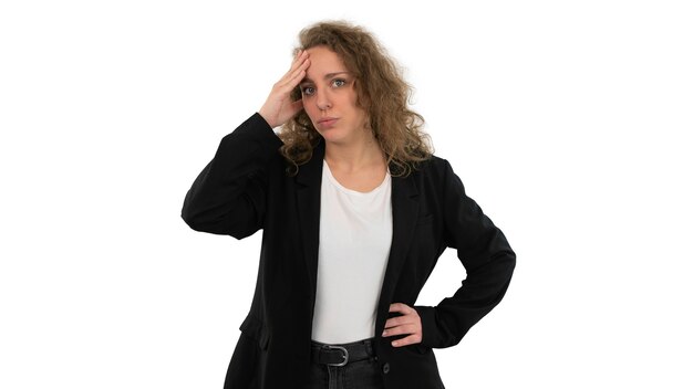 Beautiful woman in suit with hand on head showing gesture of concern or anger. Isolated on white background.