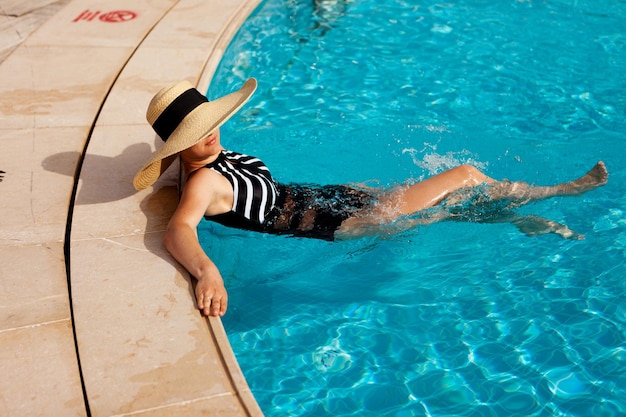 Beautiful woman sunbathing in the pool top view horizontal summer background poster mock up for design