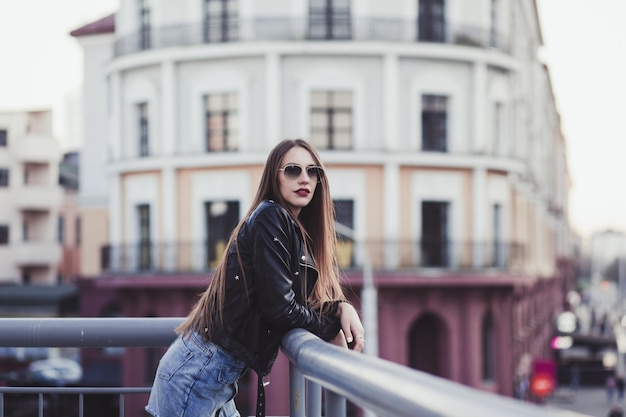 Beautiful woman in sunglasses and leather jacket