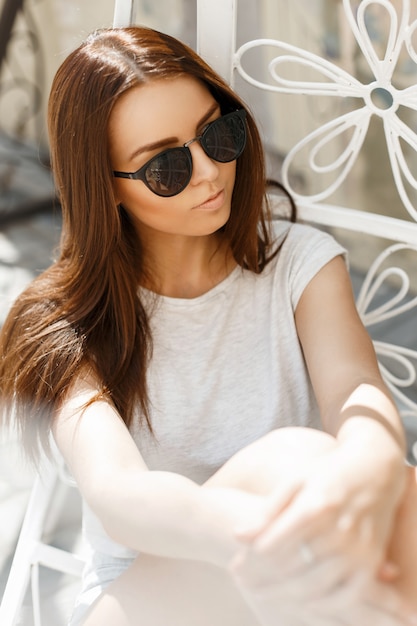 Beautiful woman in sunglasses on a summer sunny day rest