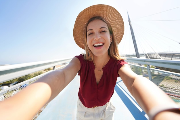 Beautiful woman takes self portrait on Pescara modern bridge in Abruzzo region Italy