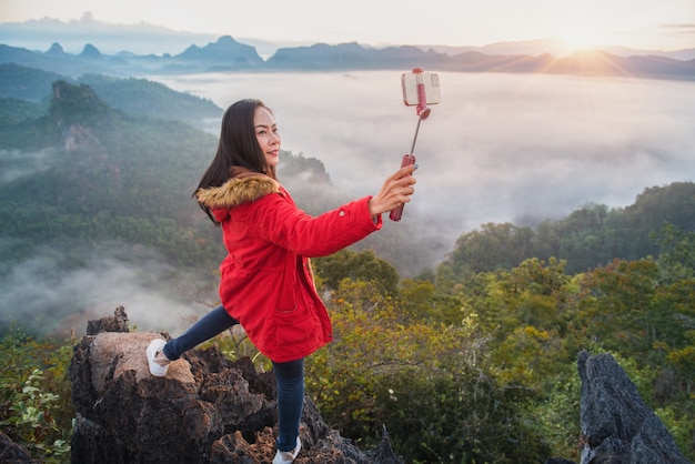 A beautiful woman taking a selfie on Phu Pha Mok Ban Jabo in Mae Hong Son Province, Thailand.