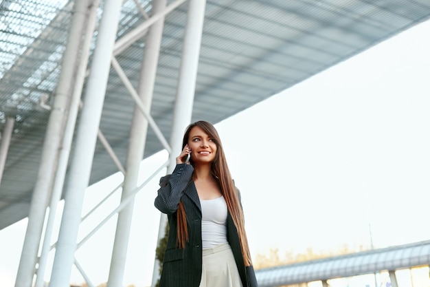 Beautiful Woman Talking On Phone Walking On Street