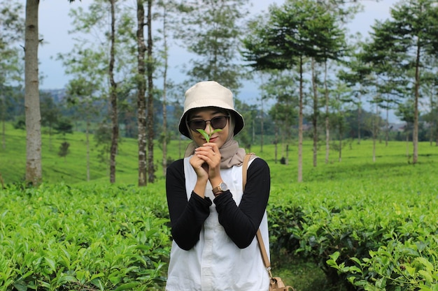 A beautiful woman in a tea garden is enjoying the beauty of nature Travel photography