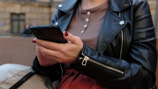 Beautiful Woman Texting On City Street
