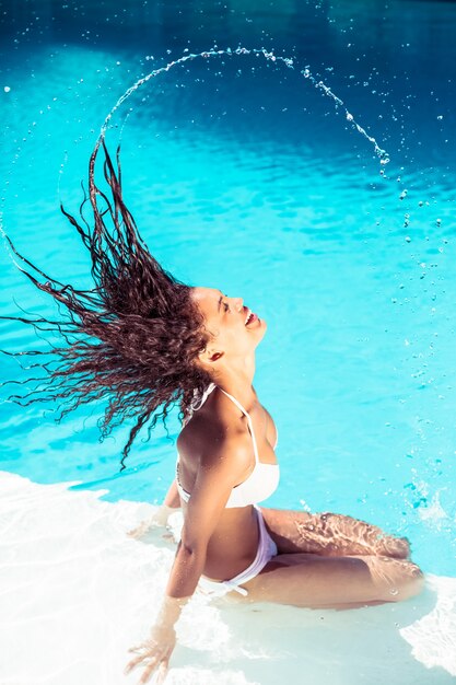 Beautiful woman tossing her wet hair