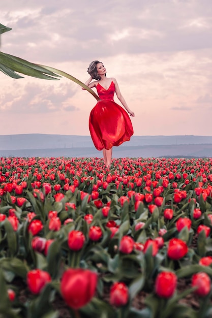 Beautiful woman in tulips field