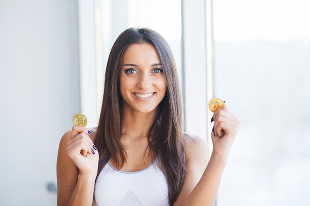 Beautiful Woman in Underwear. Close up Concept. Young Woman With a Bitcoin Cryptocurrency