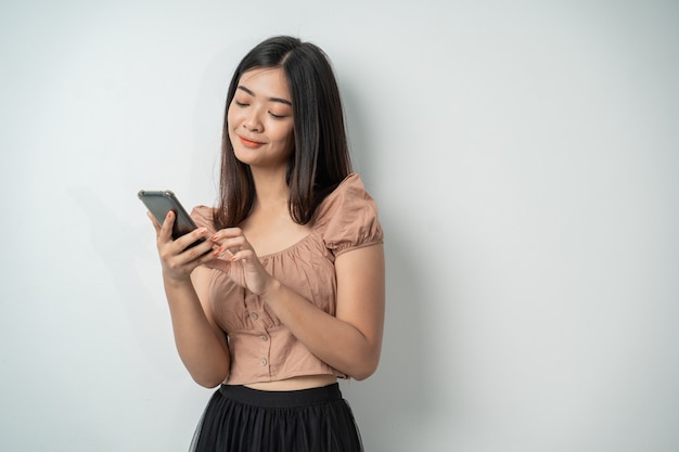 Beautiful woman uses a smartphone gadget and touches the screen