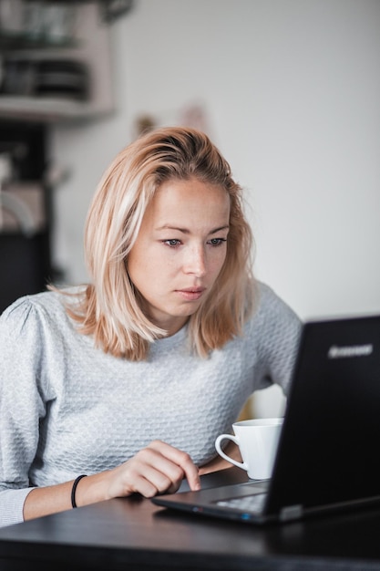 Beautiful woman using laptop at home