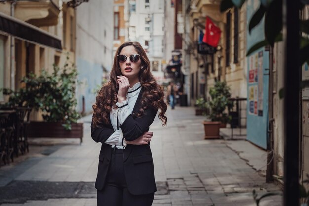 Beautiful woman walks at Istiklal streeta popular location in Beyoglu districtIstanbulTurkey walking on Istanbul street and enjoy arabic city architecture