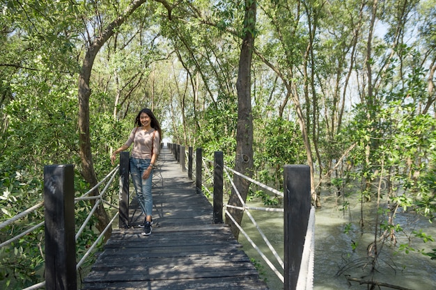 Beautiful woman walks the mangrove forest