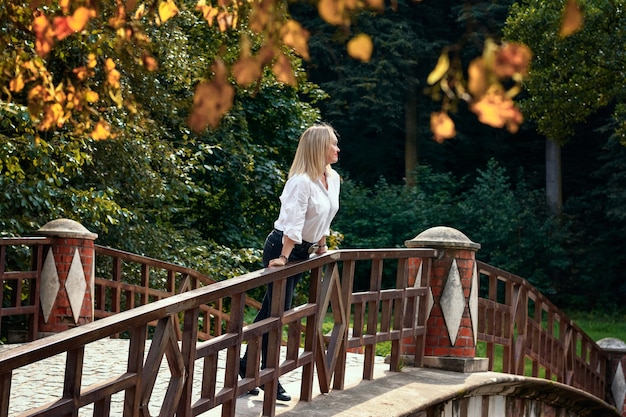 A beautiful woman walks in the park