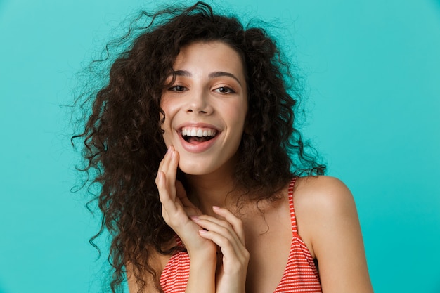 beautiful woman wearing casual clothing laughing, standing isolated over blue wall