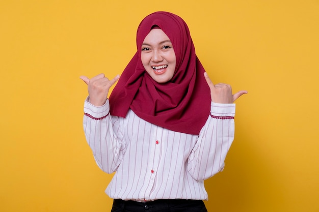 Beautiful woman wearing hijab give two thumb smile and fun gesture