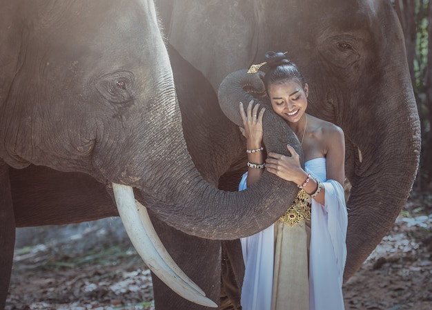 Beautiful woman wearing Thai silk traditional dresses with elephant, Surin Province, Thailand
