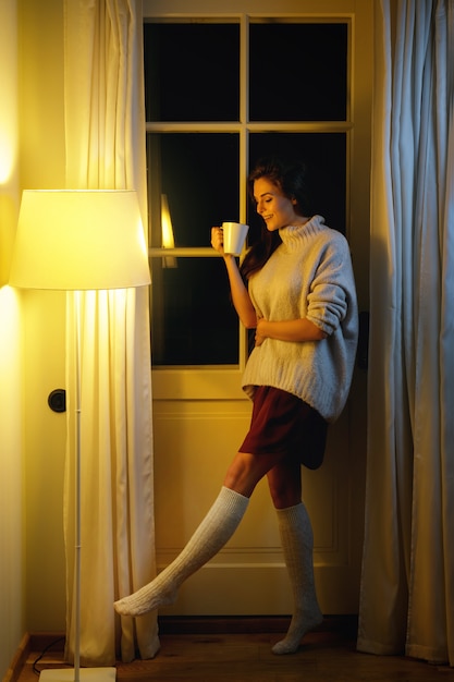 Beautiful woman wearing warm sweater and socks