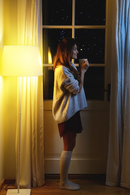 Beautiful woman wearing warm sweater and socks