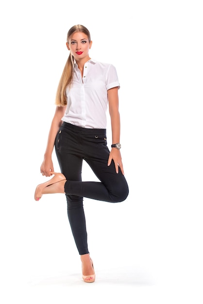 Beautiful woman on a white background in a light shirt and black trousers.