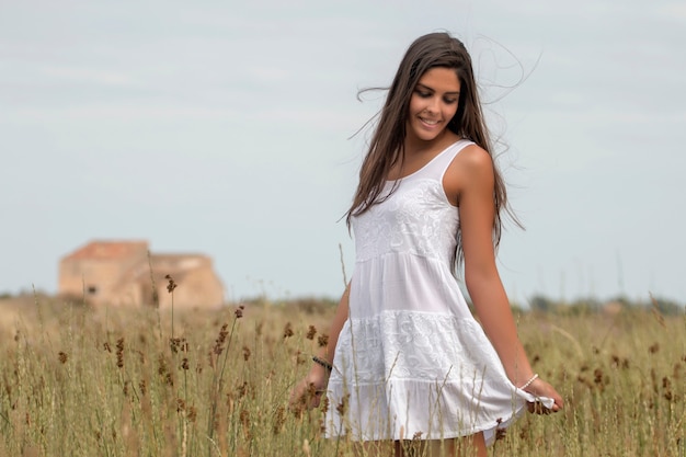 Beautiful woman on a white dress