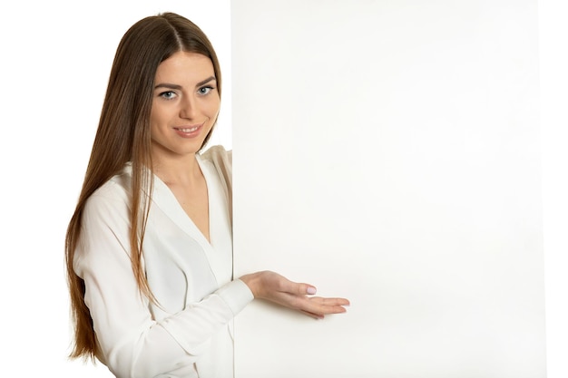 Beautiful woman and white signboard ard or copyspace for slogan or text, isolated over white background