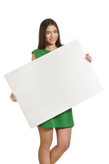 Photo beautiful woman and white signboard or copyspace for slogan or text, isolated over white background