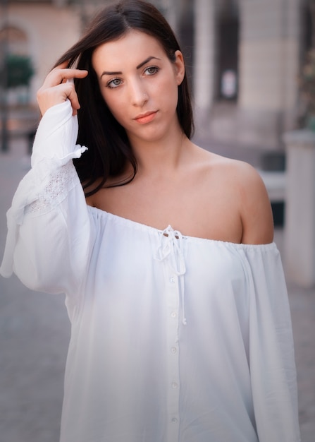 A beautiful woman in a white summer dress