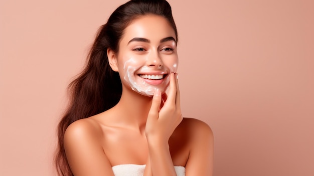 beautiful woman in white towel on her shoulders applying cream on her face