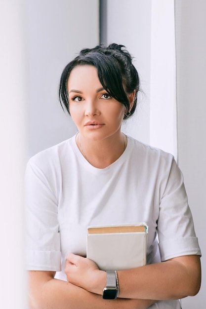 beautiful woman on the window with a book Free time education self development concept