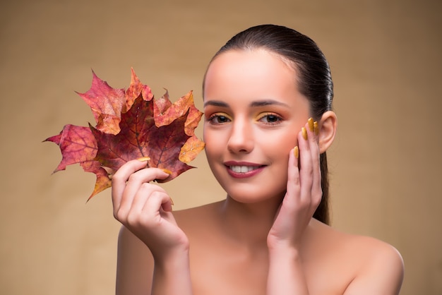 Beautiful woman in with autumn dry leaves