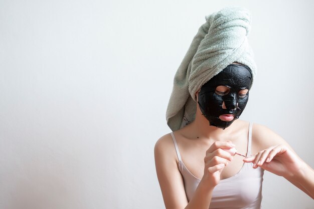 Beautiful woman with Black facial mask, lifestyle concept 