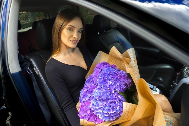 Beautiful woman with a bouquet of hydrangeas