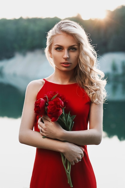 Beautiful woman with a bouquet of peony