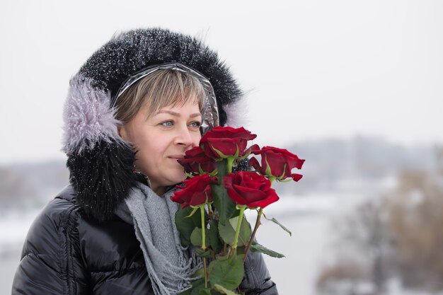 Beautiful woman with bouquet of red roses on valentine's day