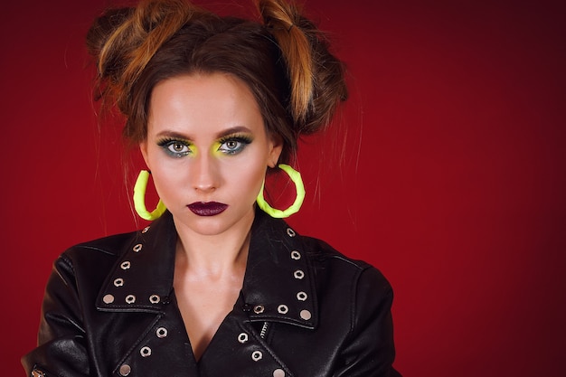 Beautiful woman with bright makeup in a black jacket