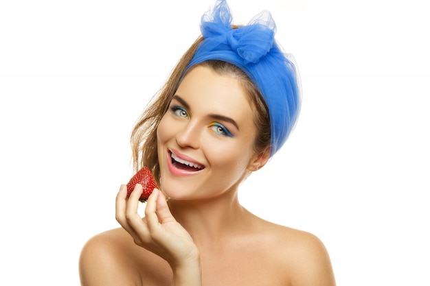 Beautiful woman with colorful make-up and strawberry