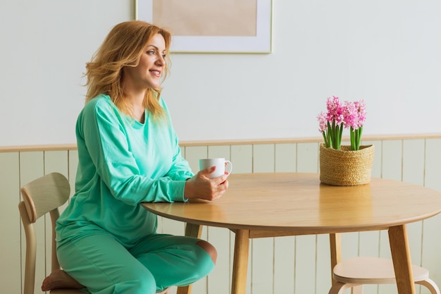 Beautiful woman with cup of hot tea