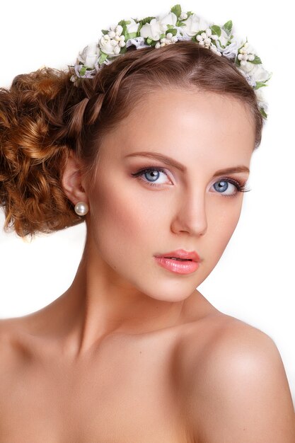 Beautiful woman with a floral ornament in her hair.