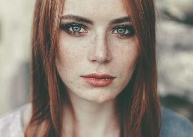 Beautiful woman with freckles in the nature