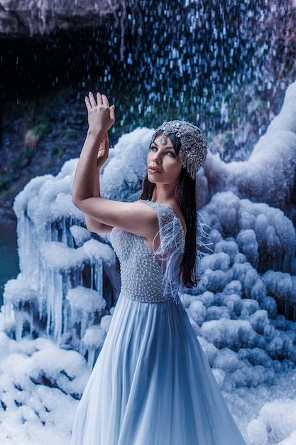 Beautiful woman with frozen icefall