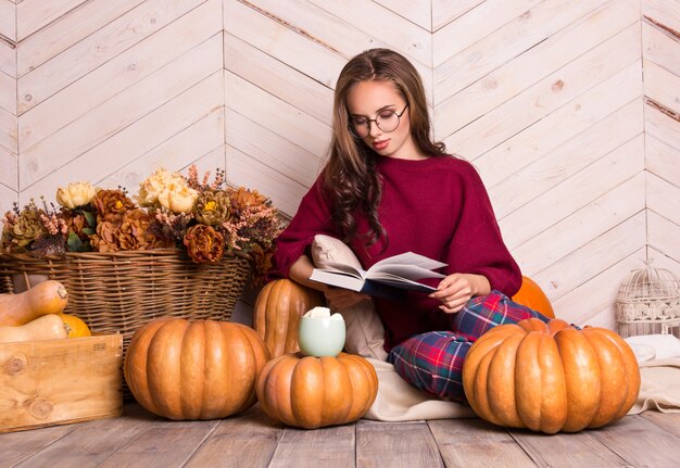 Beautiful woman with glasses reads a book