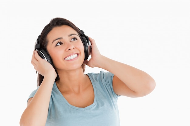 Beautiful woman with headphones looking at something