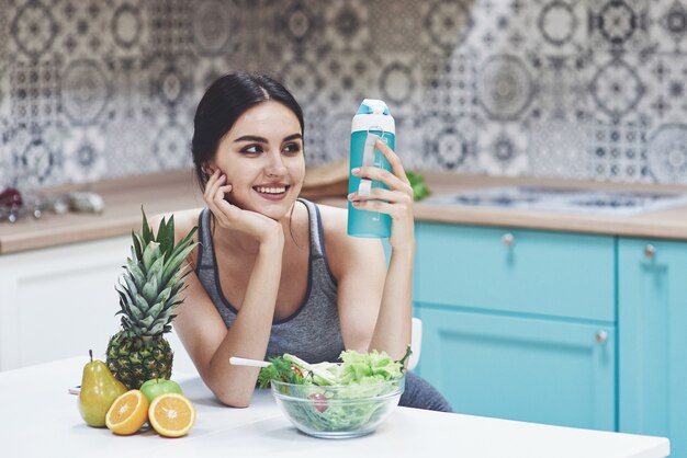 Beautiful woman with healthy food fruit in the kitchen